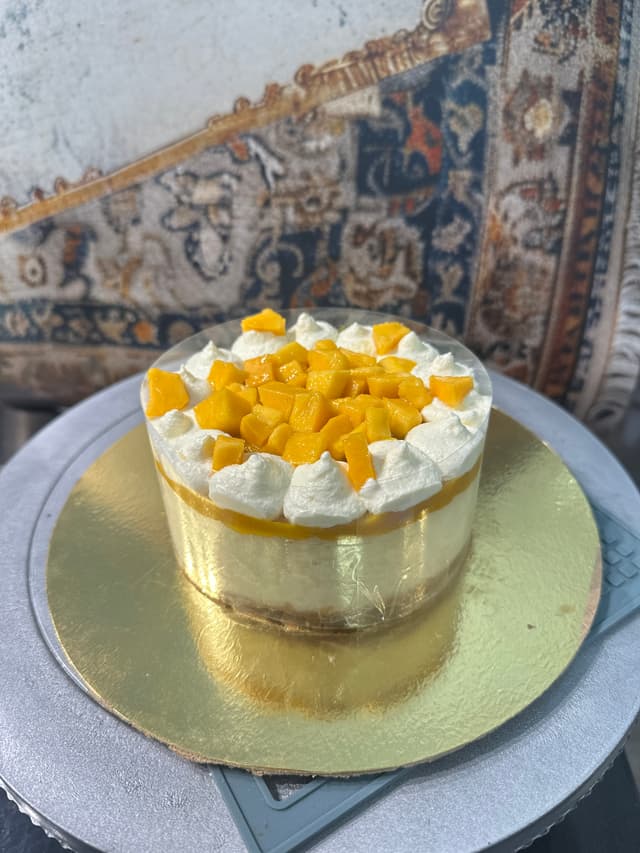 Eggless mango cheesecake topped with fresh mango