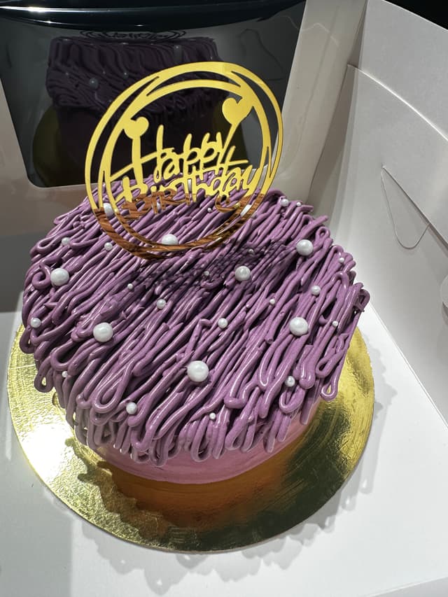 Custom celebration cake with purple buttercream finish